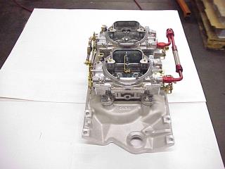 Carburetor And Intake Manifold On Work Bench